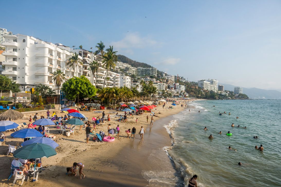 Beachgoers enjoy Playa de los Muertos in Puerto Vallarta, Mexico. This lively area is popularly known as the Zona Romántica, or Romantic Zone.