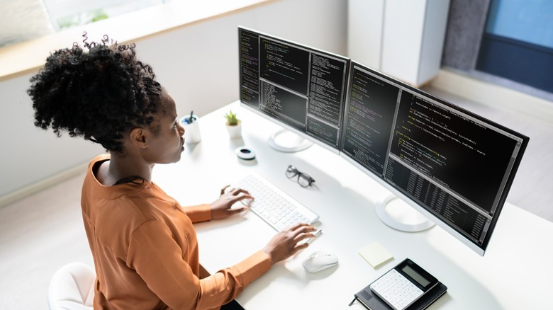 a person using an ultrawide display with multiple windows open