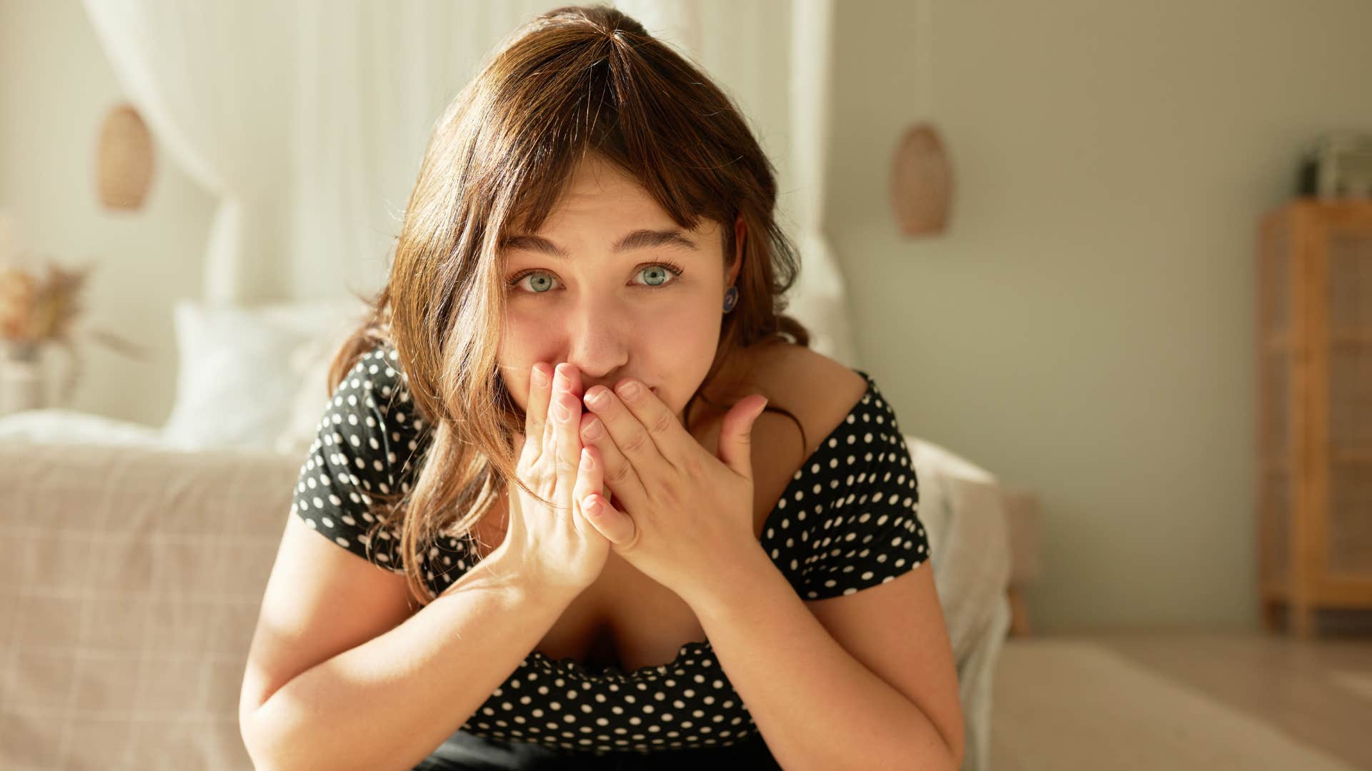 startled woman covering her mouth