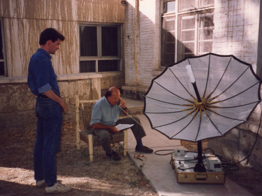 Peter Bergen and Peter Arnett make a phone call with a satellite telephone, in Afghanistan in 1993.