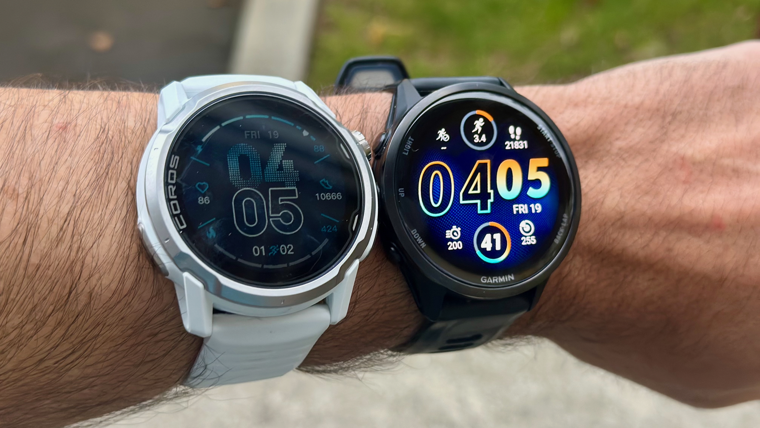 A photo of the COROS APEX 4 and Garmin Forerunner 970 strapped onto the same arm.