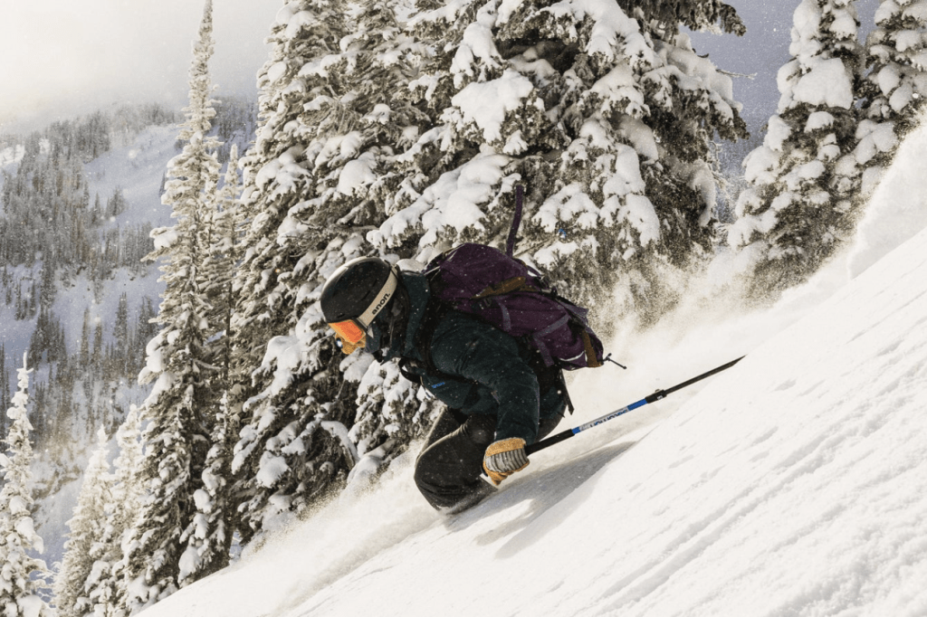 skier wearing renoun skis down mountain