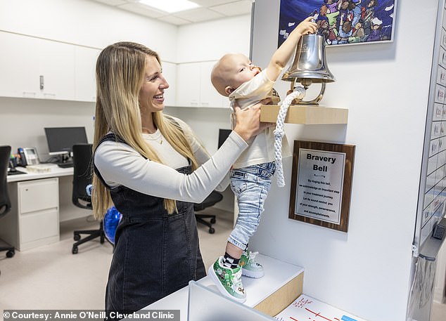Taylor Dearth, Crew's aunt, is pictured above helping Crew ring the Bravery Bell at Cleveland Clinic, a sign that he had finished cancer treatment