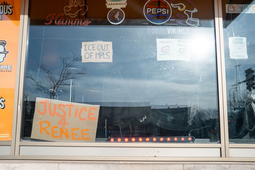 Messages in solidarity with Renee Good are displayed in windows of the Midtown Global Market on January 20 in Minneapolis.