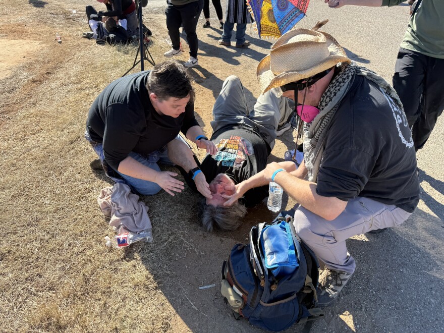 Protesters help one another rinse their eyes after a chemical irritant was deployed outside the Dilley ICE detention facility on Wednesday, Jan. 28, 2026.