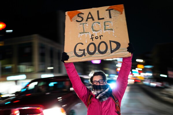 A protester rallies against the presence of U.S. Immigration Customs Enforcement in Maine, Friday, Jan. 23, 2026, in Portland, Maine. (AP Photo/Robert F. Bukaty)