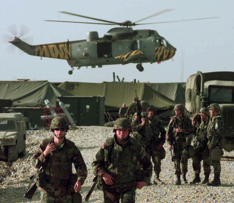 A British military helicopter, painted with tiger stripes, lands near the U.S. Army camp at the Tirana, Albania airbase, Friday, April 30, 1999.