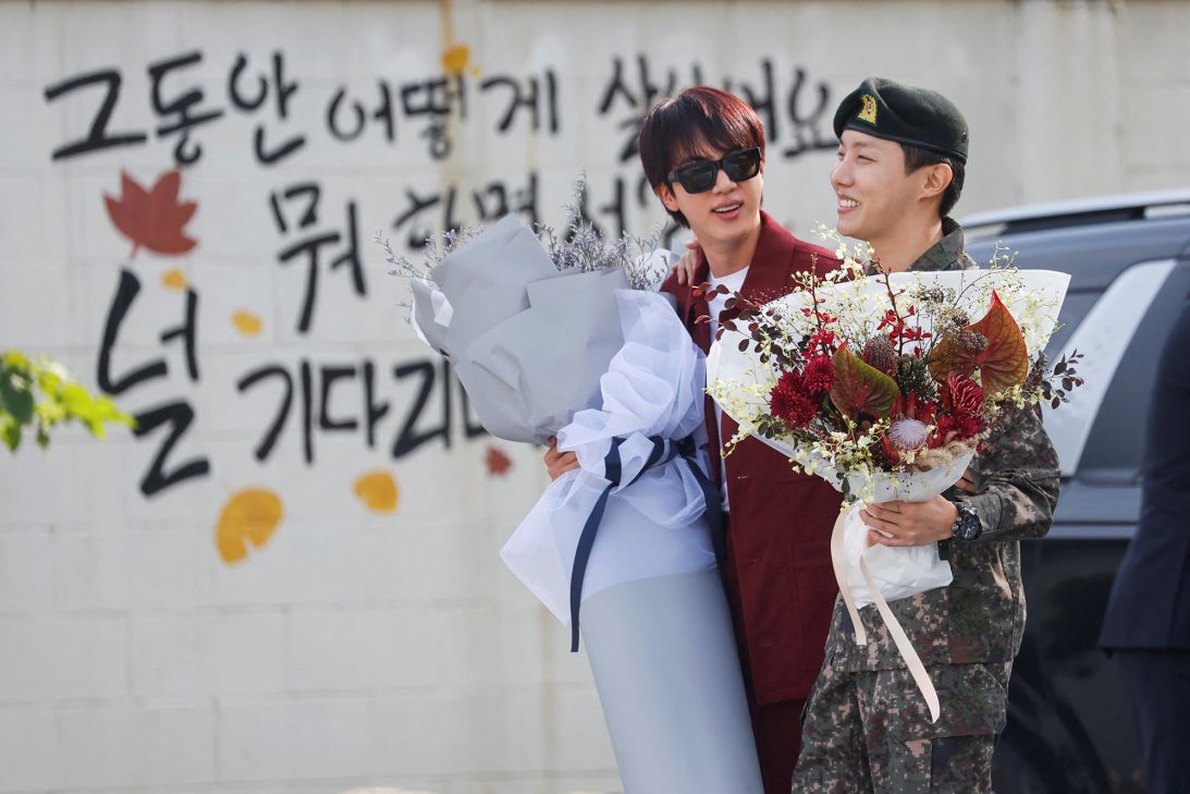 J-Hope is greeted by fellow BTS member Jin after being discharged from his 18 months of mandatory military service, outside a military base in Wonju, South Korea, on October 17, 2024.