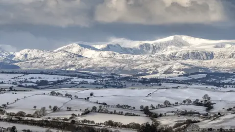 Getty Images Aerial view or snow-covered mountains and countryside near Llanrwst