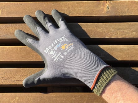 a person wearing ATG MaxiFlex Ultimate Work Gloves and wool liners