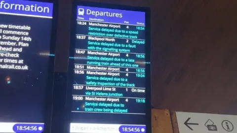 Amelka Zambrzycka An image of a departures board at a train station. It shows multiple services are delayed due to a signally fault or a speed restriction over defective track. 