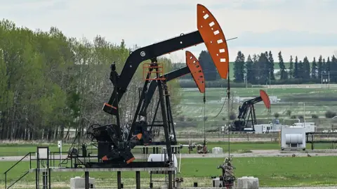 AFP via Getty Images Oil wells in Canada