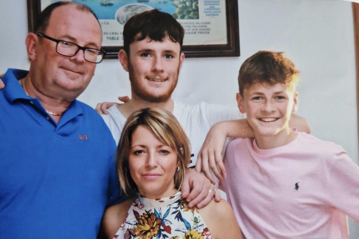 Richard Abrahams / SWNS Luke Abrahams with his parents and younger brother Jake