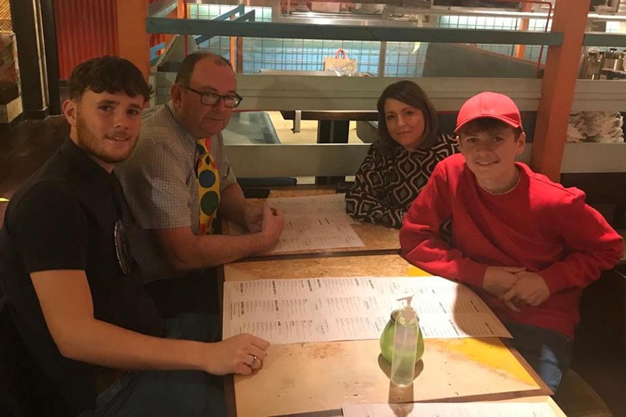 Richard Abrahams / SWNS Luke Abrahams with his parents and younger brother Jake