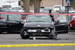 Crime tape surrounds a vehicle at the scene of a U.S. Border Patrol shooting of two people at building three of Adventist Health on the 10000 block of Main Street in Portland on Jan. 8, 2026.