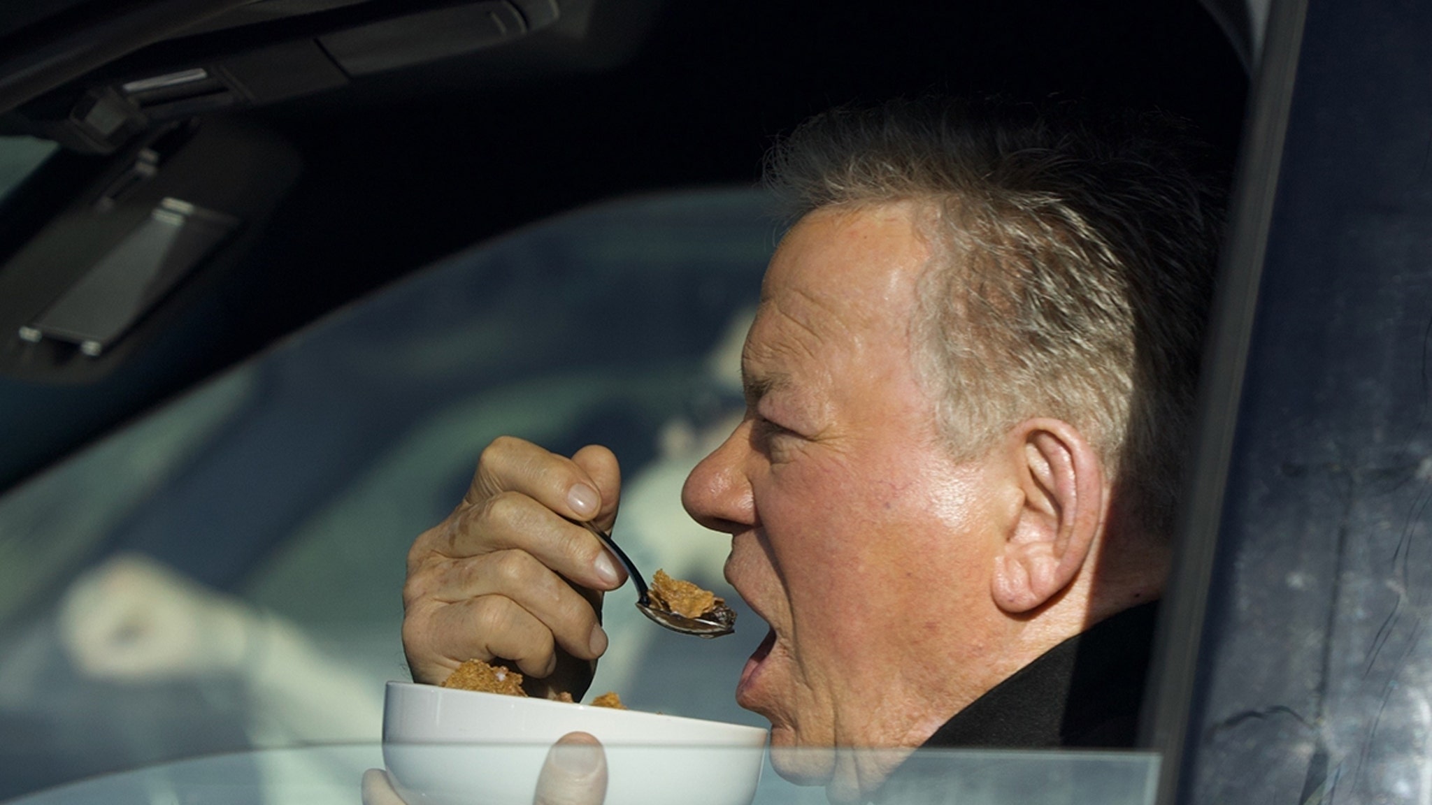  William Shatner Photographed Eating Bowl of Cereal in His Car at Stop Light
