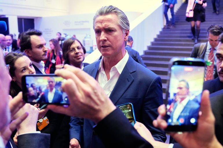 Gavin Newsom surrounded by cellphone cameras at Davos