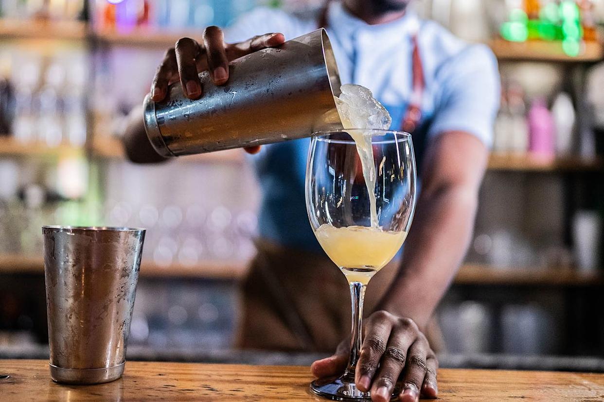 Stock image of a bartender making a cocktail. Getty