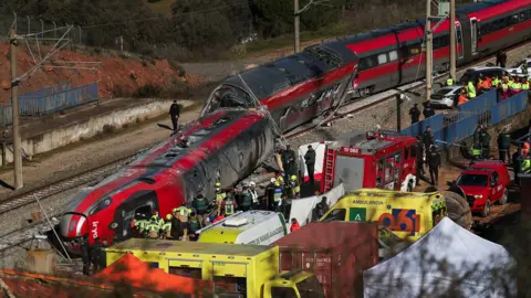 Reuters Responders and emergency workers surround the derailed train with ambulances and personnel in a wide shot taken on Monday.