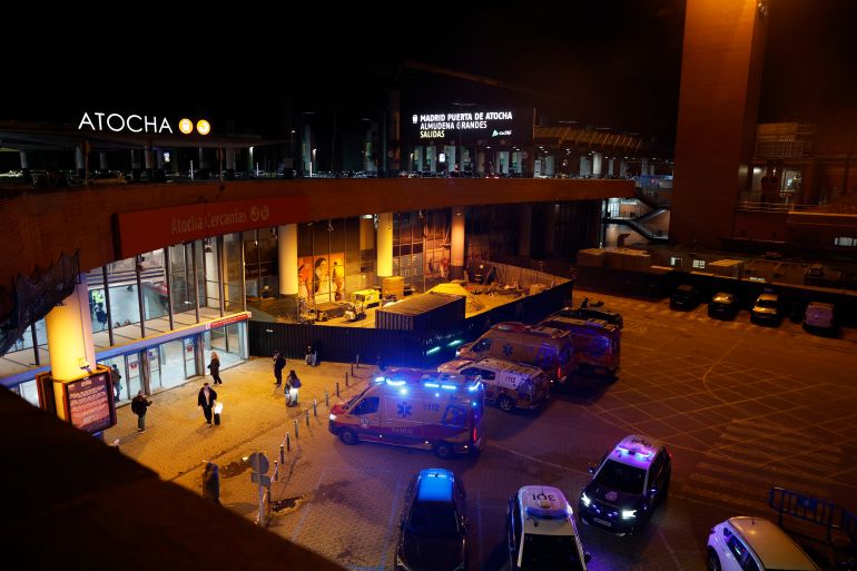 epa12659752 Ambulances gather at the Puerta de Atocha train station in Madrid, Spain, 18 January 2026. The Samur Emergency Team offered its assistance to Adif/Renfe and deployed a team with a psychologist and a basic ambulance in case relatives of passengers arrive after the derailment of two high-speed trains in the municipality of Adamuz. EPA/JAVIER LIZON
