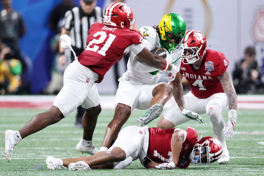 Noah Whittington is tackled by Rolijah Hardy during the second quarter.