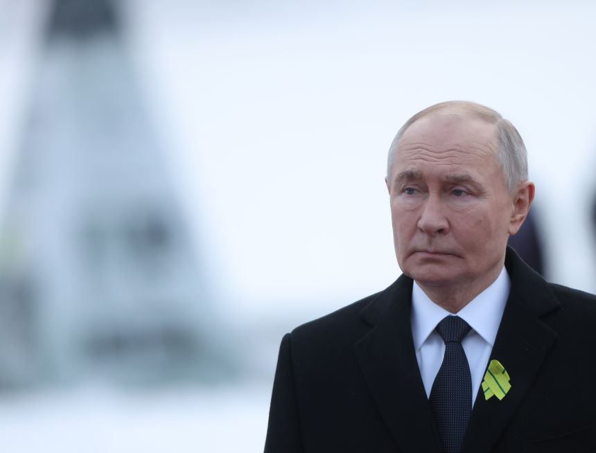 Russian President Vladimir Putin follows honour guards carrying a wreath at Piskaryovskoye Memorial Cemetery, dedicated to the victims of the siege of Leningrad, in Saint Petersburg, on January 27, 2026