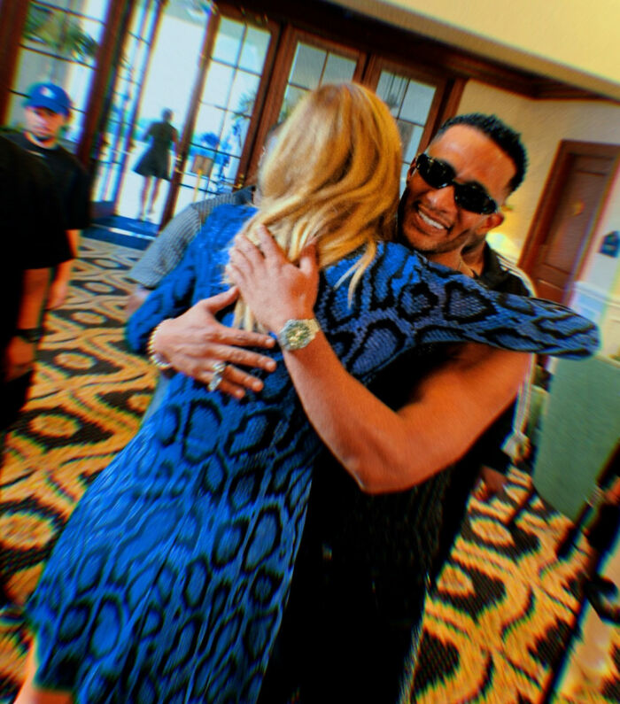 Lara Trump hugging a man indoors with blurred background, highlighting her dance moves in a new music video.