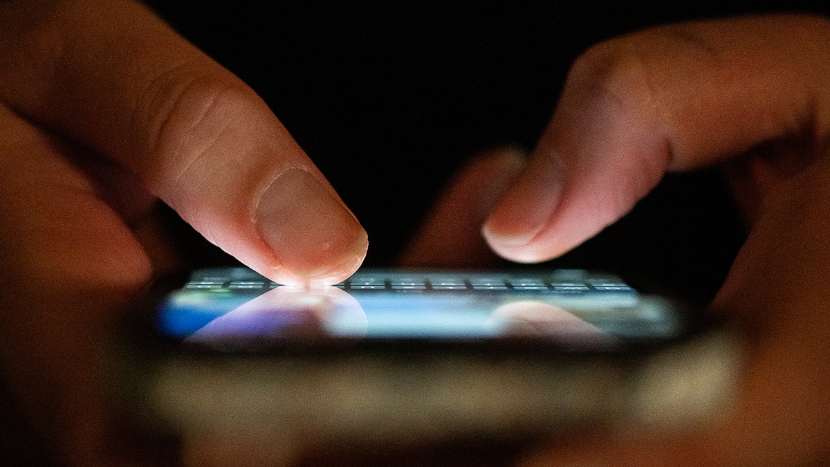 Person using their iPhone.