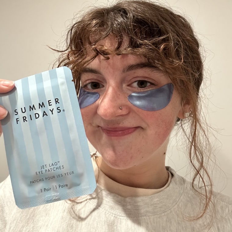 Woman wearing Summer Fridays eye patches and showing packaging