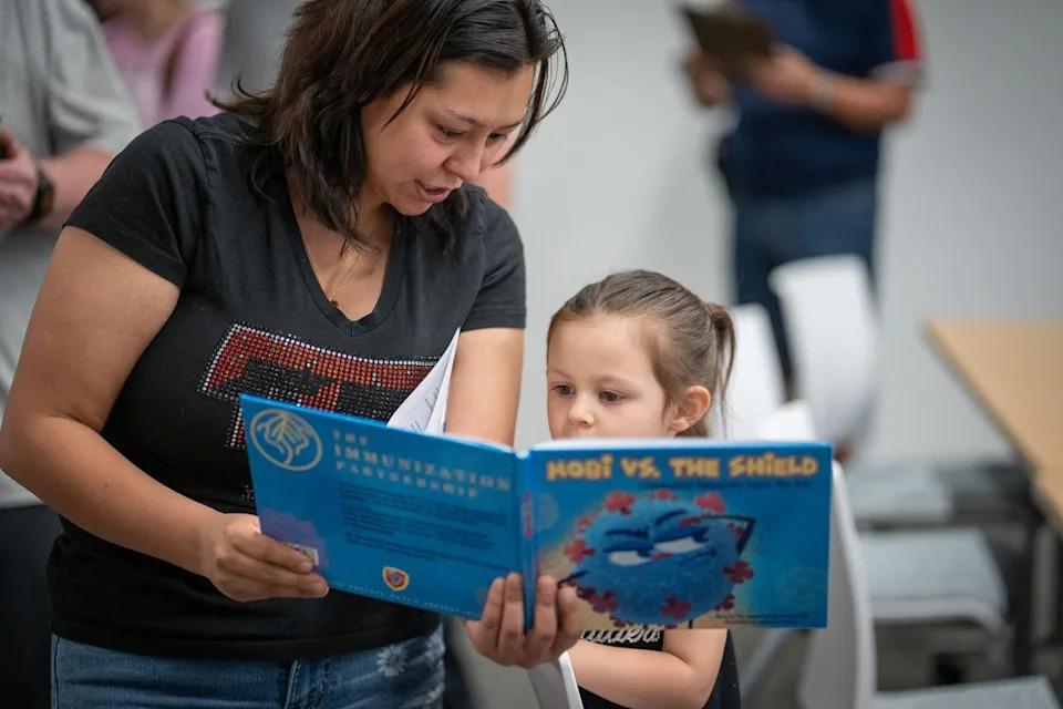 A mother and daughter read together at a vaccine clinic in West Texas last year. Cases in South Carolina have since exceeded those reported in the Lone Star State’s outbreak (Getty Images)
