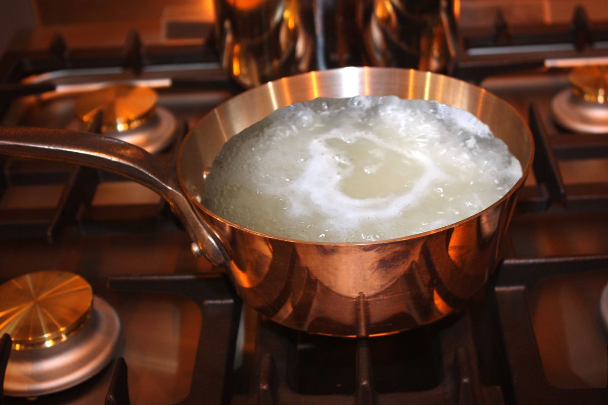 Boiling water in a copper pot for cooking rice