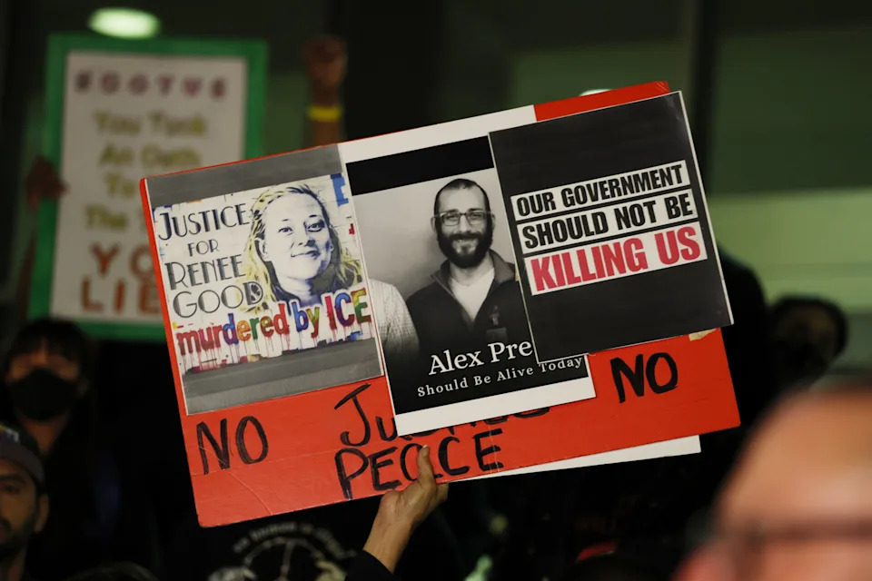 A sign is raised in support of Renee Good and Alex Pretti at a candle light vigil during a peaceful protest in support of a 37-year-old man shot and killed by immigration officers in Minneapolis was under way Saturday evening along Olvera Street in Los Angeles. / Gina Ferazzi / Los Angeles Times via Getty Imag