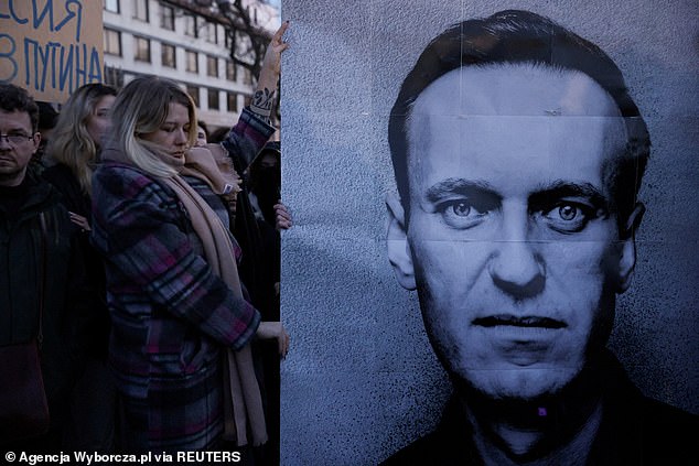 After Navalny's death, people gathered across Europe to mourn (Pictured: Mourners at the Russian embassy in Warsaw, Poland)