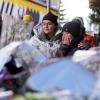 People mourn behind flowers and letters near the sealed off Le Constellation bar, where a devastating fire left dead and injured during the New Year's celebrations in Crans-Montana, Swiss Alps, Switzerland, on Friday, Jan. 2.