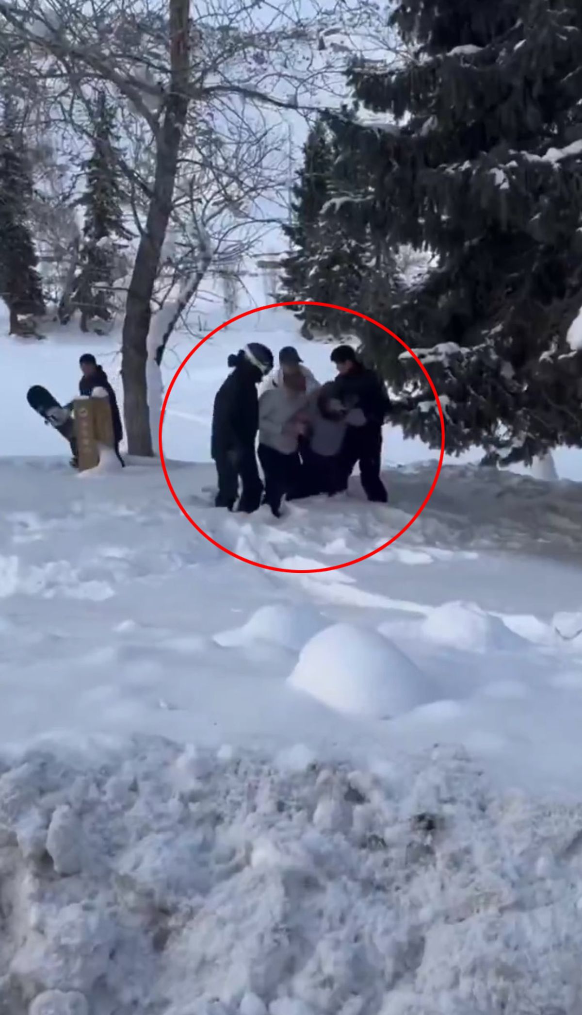 Woman being helped through snow after she is attacked