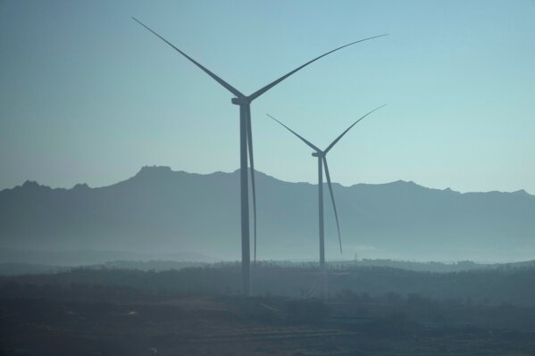 Wind turbines are seen from a train from Beijing to Shenyang in northwestern China on Jan. 3, 2026. (AP Photo/Ng Han Guan)