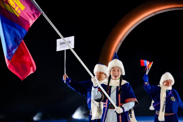 Ariuntungalag Enkhbayar, the flag bearer of Mongolia, takes part in the athletes parade during the Olympic opening ceremony at the 2026 Winter Olympics, in Predazzo, Italy, Friday, Feb. 6, 2026. (AP Photo/Matthias Schrader)