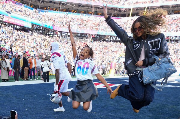 Blue Ivy Carter poses for photos in the end zone before the NFL Super Bowl 60 football game between the New England Patriots and the Seattle Seahawks, Sunday, Feb. 8, 2026, in Santa Clara, Calif. (AP Photo/Julio Cortez)