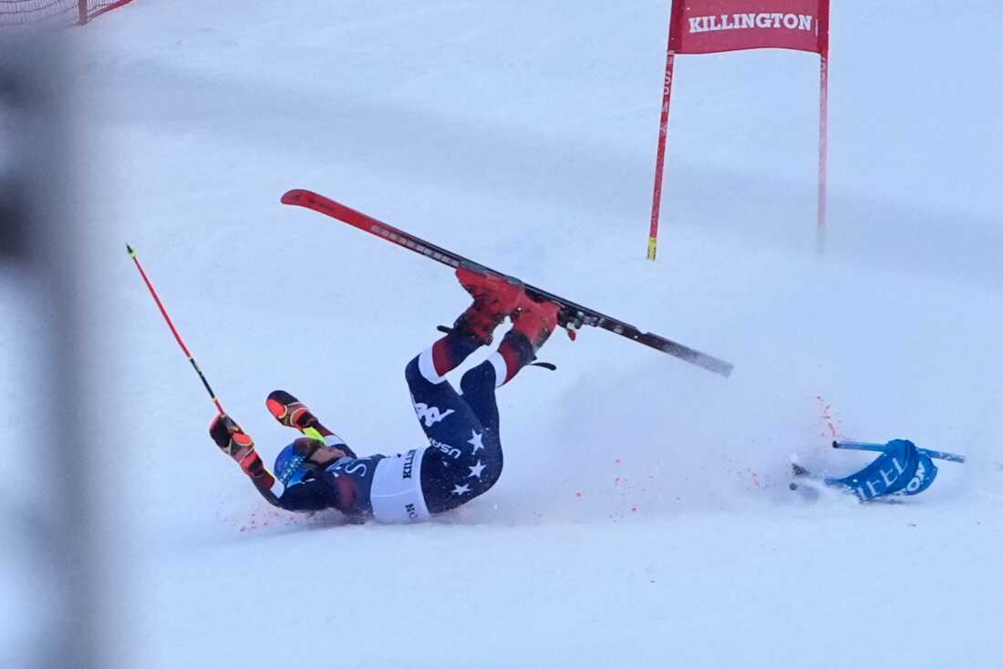 Mikaela Shiffrin tumbles onto her back in the snow after crashing in the giant slalom skiing race.
