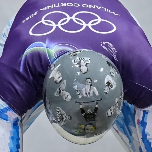 Ukraine's Vladyslav Heraskevych arrives at the finish during a men's skeleton training session at the 2026 Winter Olympics, in Cortina d'Ampezzo, Italy, Tuesday, Feb. 10, 2026. (AP Photo/Alessandra Tarantino)