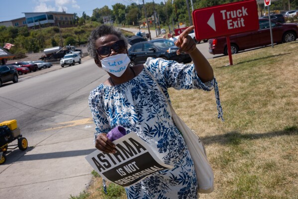 Clairton resident and environmental advocate Melanie Meade stands at the entrance of the Clairton Coke Works in Clairton, Pa., on Tuesday, Aug. 12, 2025, a day after an explosion at the facility killed two workers. (Quinn Glabicki/Pittsburgh's Public Source via AP)