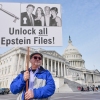 Gary Rush, of College Park, Md., holds a sign before a news conference on the Epstein files in front of the Capitol, on Tuesday, Nov. 18, 2025, in Washington, D.C.