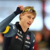 Speedskater Jordan Stolz raises one fist during the men's 1000 meters in Germany.