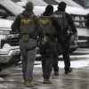 ICE agents depart the Bishop Henry Whipple Federal Building on Feb. 4, 2026 in Minneapolis, Minn.