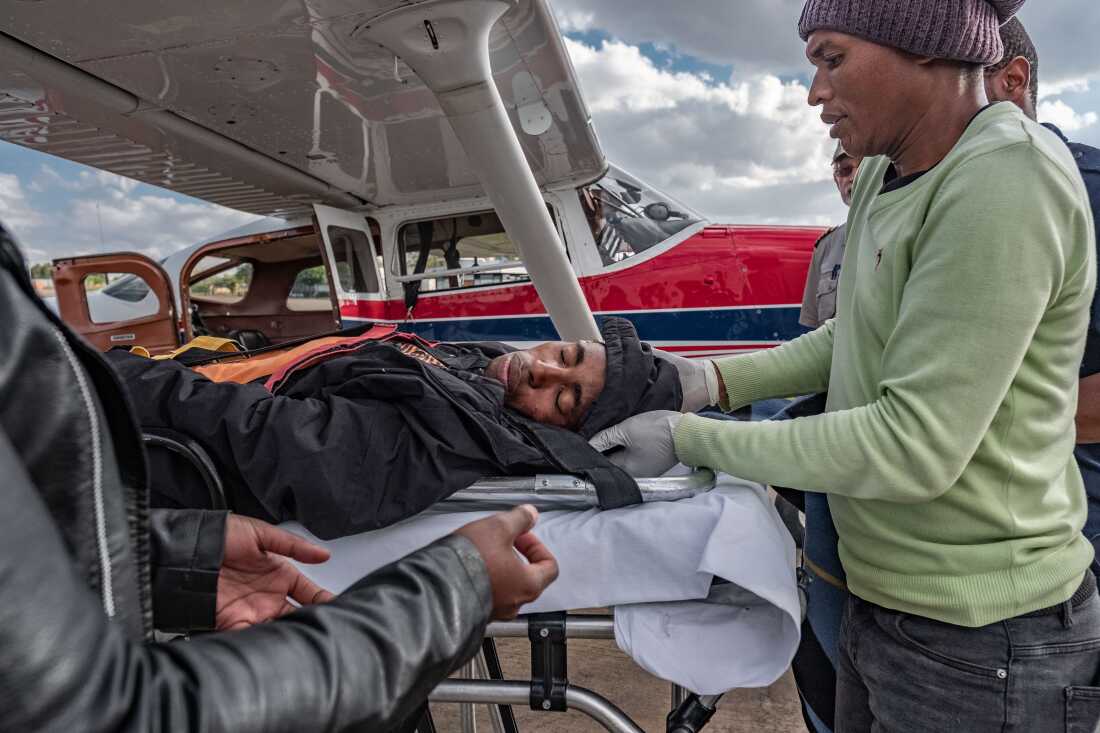 Tlotliso Lebeta, 24, is transferred from a MAF Cesna airplane to an ambulance in Maseru, Lesotho. Lebeta had been flown on an emergency flight from the distant district of Mokhotlong after sustaining head injuries in a horse riding accident. With its mountainous terrain and limited road network, Lesotho's health system relies on the work of the Lesotho Flying Doctor Service and its MAF partners for evacuation flights and transportation of doctors, medicines and supplies to rural clinics.
