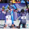 Sweden's Sara Hector, right, and Norway's Thea Louise Stjernesund bow to Italy's Federica Brignone, center, at the finish area of an alpine ski, women's giant slalom race, at the 2026 Winter Olympics, in Cortina d'Ampezzo, Italy, after Brignone captured another gold medal.