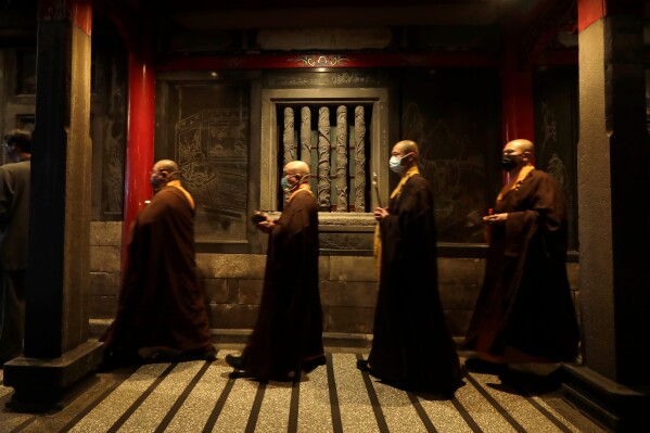Monks pray on the eve of the Lunar New Year celebrations in Taipei, Taiwan, Monday, Feb. 16, 2026. (AP Photo/Chiang Ying-ying)