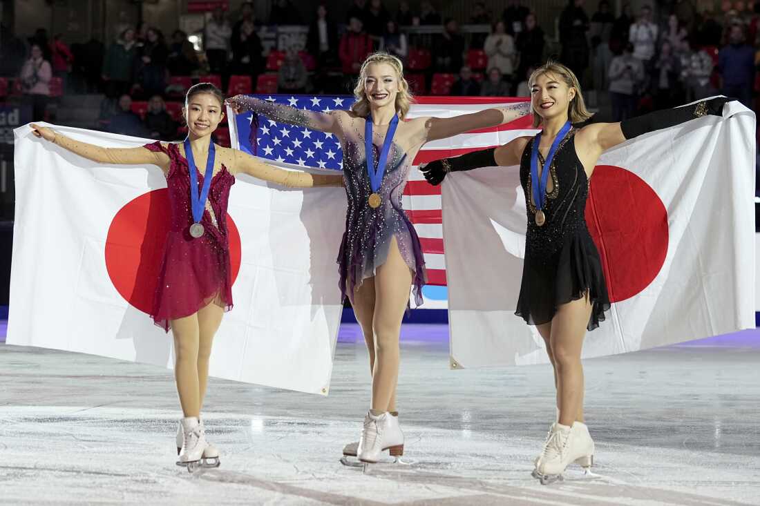 Silver medalist Mone Chiba, gold medalist Amber Glenn and bronze medalist Kaori Sakamoto pose after the women's event at the 2024 ISU Grand Prix Finals.