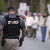 A Krome Detention Center officer patrols as people hold a vigil to recognize those who have died in U.S. Immigration and Customs Enforcement custody as well as those affected by mass deportations on May 24 outside Krome Detention Center in Miami.