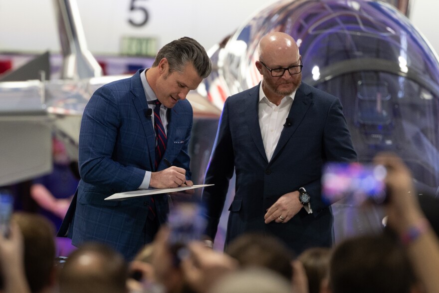 U.S. Secretary of War Pete Hegseth signs a plane fin with his name and the slogan “speed and strength” prior to speaking to a crowd of Boeing employees. Hegseth encouraged the company to develop technology at a higher and faster rate and praised the company’s decision to relocate to the St. Louis area.
